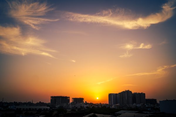 Beautiful sunset with dramatic clouds over Karachi's skyline, blending urban architecture with nature. Nature 4K