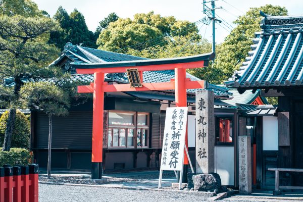 Beautiful torii gate entrance to a shrine in Kyoto, Japan, surrounded by lush greenery. Anime 4K