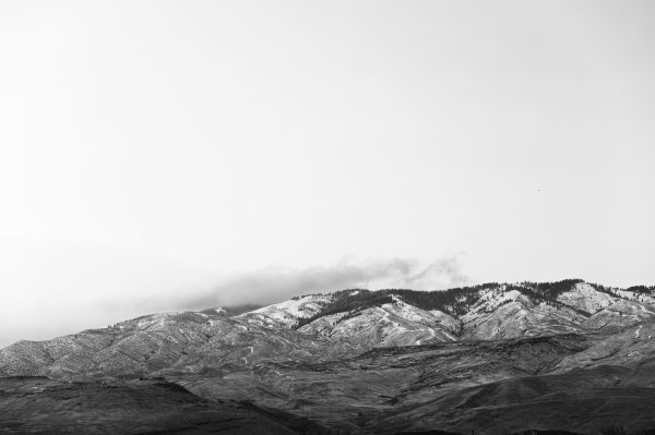 Black and white landscape showcasing a serene mountain range under a soft sky. Nature 4K