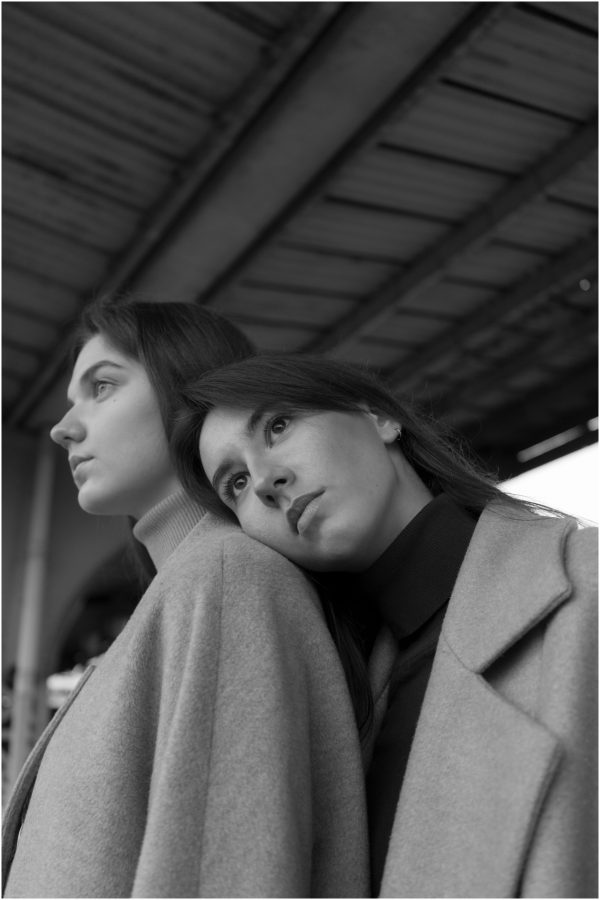 Black and white of thoughtful woman leaning head on shoulder of young girlfriend while looking away Mobile 4K