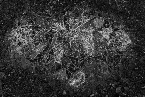 Black and white photo of abstract ice formation on rocky ground in Ushuaia. Abstrait 4K