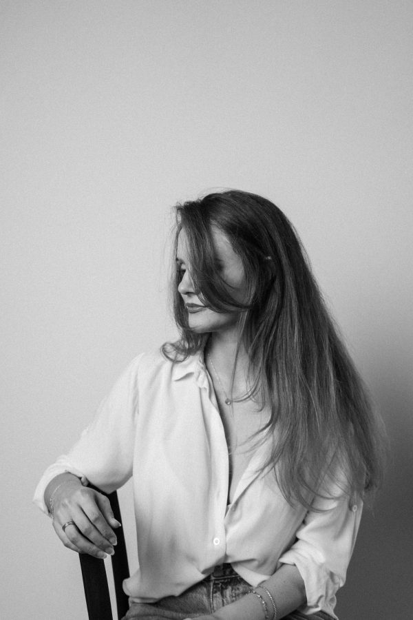 Black and white portrait of a woman seated, exuding elegance and introspection. Mobile 4K