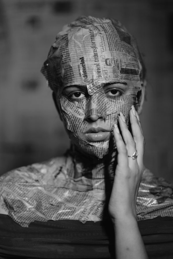 Black and white portrait with newspaper overlay on face and body. Mobile 4K