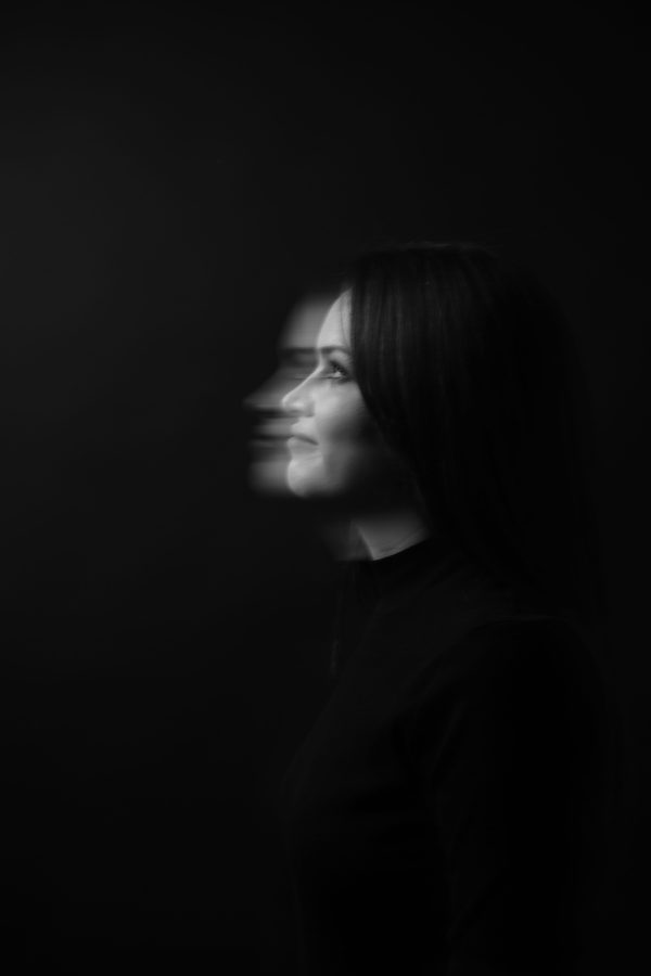 Black and white profile portrait with artistic motion blur, creating a dynamic effect. Mobile 4K