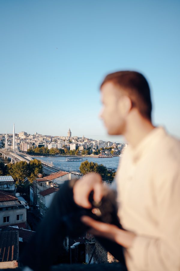 Blurred man gazing at Istanbul skyline with city and river backdrop. Mobile 4K