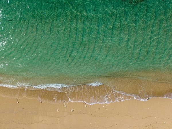 Breathtaking aerial view of emerald waters and sandy beach in Bali, Indonesia. Nature 4K