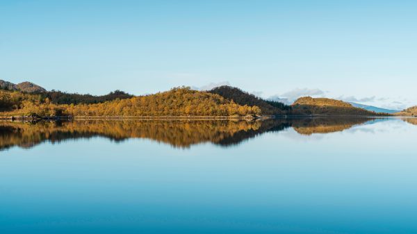 Breathtaking view of Lofoten archipelago with calm reflections and autumn foliage. Nature 4K