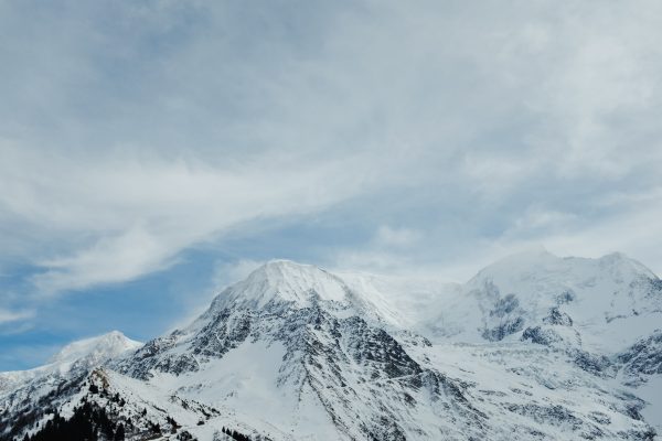 Breathtaking view of snow-covered mountains against a blue sky in winter. Nature 4K