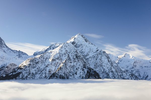 Breathtaking view of snow-covered mountains under a clear sky in Les Deux Alpes, France. Nature 4K