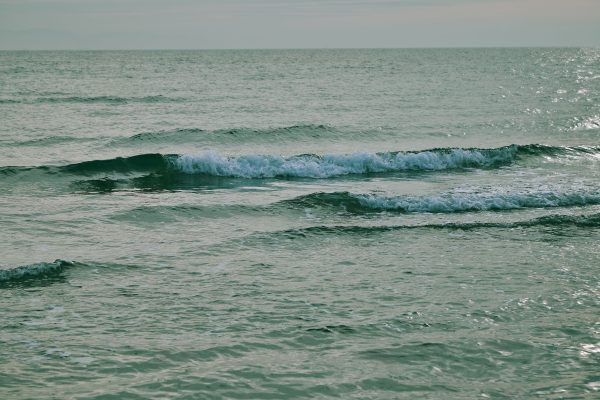 Calm waves on the ocean surface during sunset, offering a serene and tranquil seascape. Nature 4K