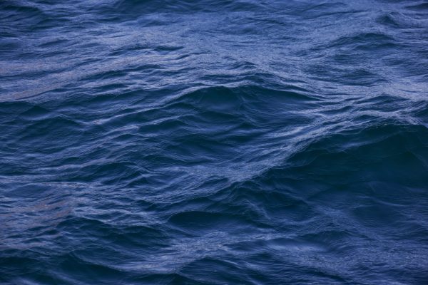 Captivating close-up of deep blue ocean waves showing texture and movement. Nature 4K