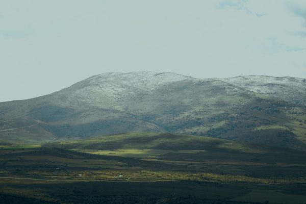 Captivating landscape of snow-dusted mountains in Kayseri, Turkey under partly cloudy skies. Nature 4K