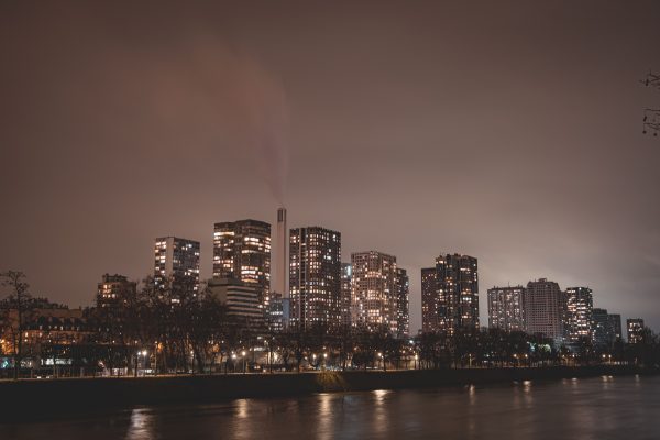 Captivating nighttime view of Paris skyline with illuminated skyscrapers along the river. Architecture 4K
