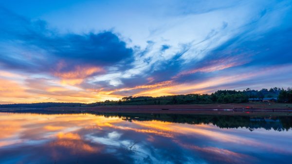 Captivating sunrise reflection on Gia Lai lake with vibrant clouds in Vietnam. Nature 4K