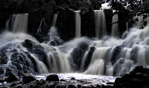 Captivating view of a cascading waterfall in Gränna, Sweden's lush wilderness. Nature 4K