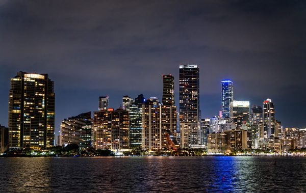 Captivating view of Miami's illuminated skyline at night, showcasing its modern architecture and vibrant city life. Architecture 4K