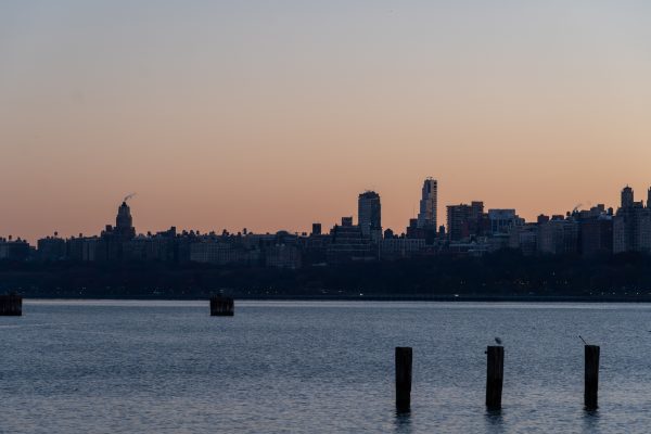 Capture of a city skyline at sunrise with calm waters in the foreground. Architecture 4K
