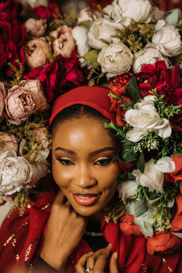Capture of a smiling woman surrounded by vibrant floral arrangement, conveying beauty and elegance. Mobile 4K