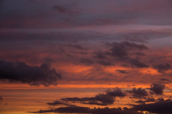 Capture of a vivid twilight sky filled with dramatic clouds in warm hues. Nature 4K