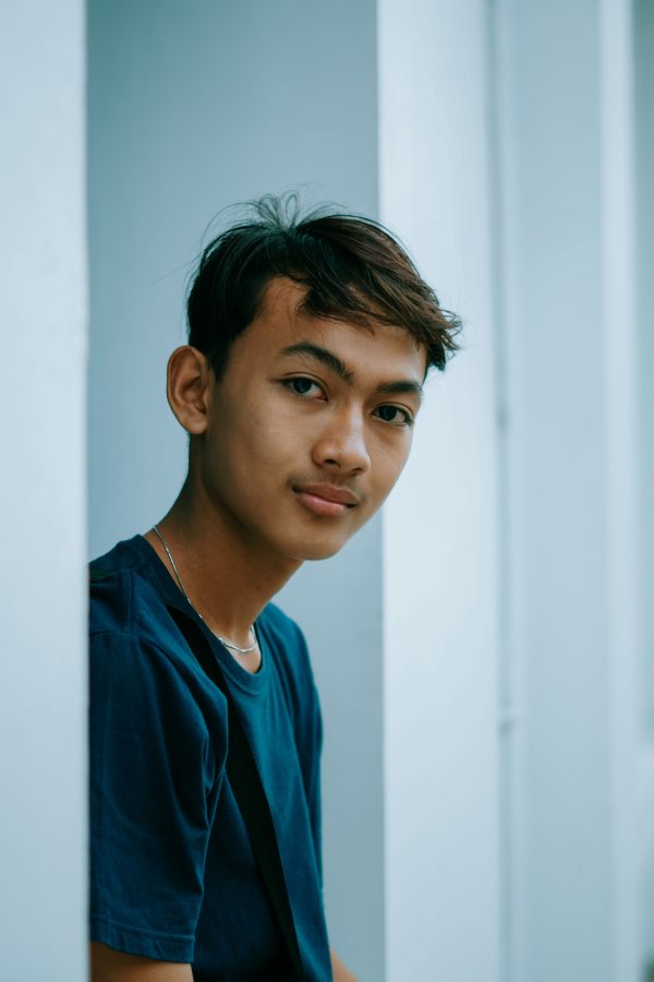 Captured in Cirebon, Indonesia, this portrait shows a young man standing indoors, exuding calmness. Mobile 4K