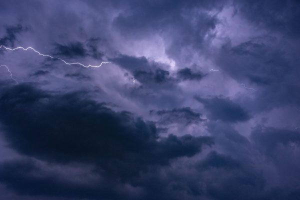 Capturing a vivid lightning storm with dark clouds in the night sky, showcasing nature's power. Dark 4K