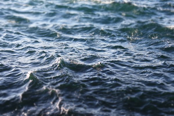 Close-up image of dynamic ocean waves under a bright blue sky. Nature 4K