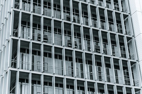 Close-up of a modern highrise building facade showcasing a grid pattern of windows and balconies. Architecture 4K