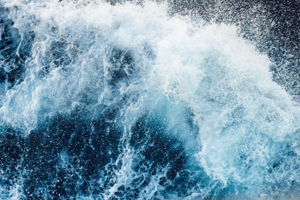 Close-up of a powerful ocean wave breaking with dramatic white foam. Nature 4K