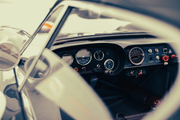 Close-up of a vintage car dashboard showcasing classic design at Le Mans, France. Voitures 4K
