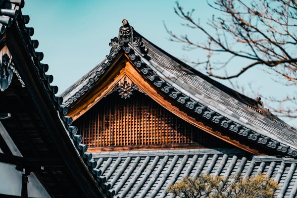 Close-up of traditional Japanese architecture roof with decorative patterns, showcasing cultural heritage. Anime 4K