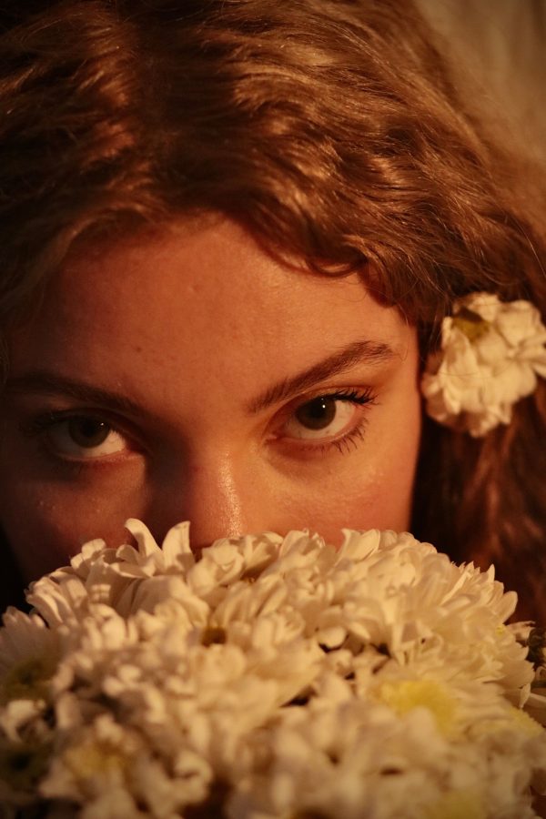 Close-up portrait of a woman with white flowers, creating a warm and intimate atmosphere. Mobile 4K