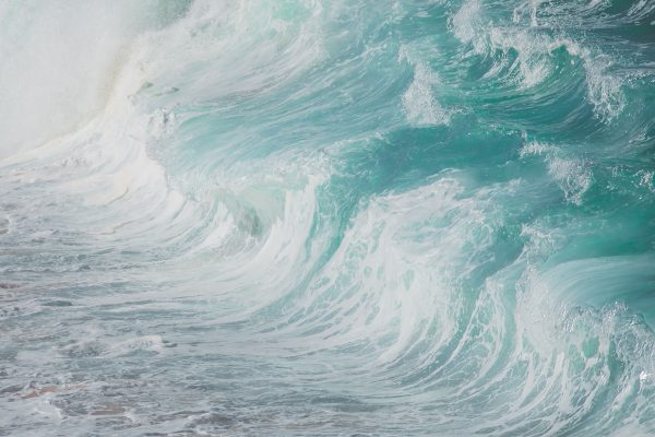 Close-up view of powerful ocean waves crashing and splashing against the shore. Nature 4K