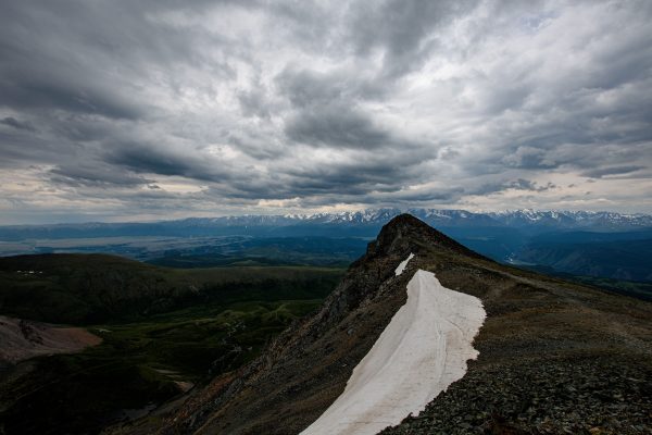 Cloud-covered peaks of the Altai Mountains in Russia, showcasing dramatic scenery and rugged terrain. Nature 4K