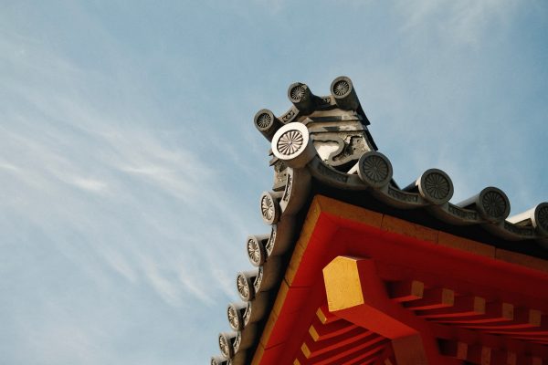 Detailed view of a traditional Japanese temple roof in Kyoto with decorative elements. Anime 4K