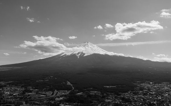Dramatic aerial black and white capture of Mount Fuji under a clouded sky. Anime 4K