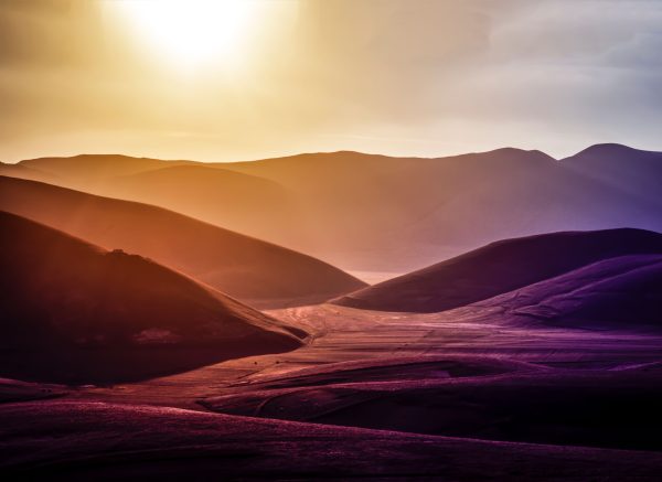Dramatic landscape of sunset over Montemonaco's hilly terrain, showcasing vibrant natural beauty. Nature 4K
