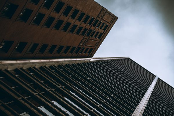 Dramatic perspective of Chicago skyscrapers with a moody, cloudy background, highlighting urban architecture. Architecture 4K