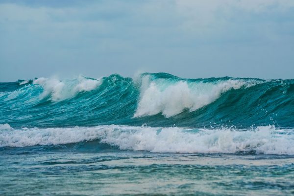 Dynamic ocean waves crash powerfully along the shoreline showcasing nature's strength. Nature 4K