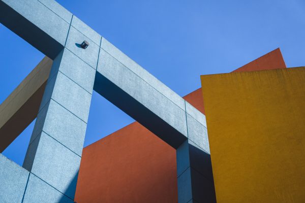 Dynamic shot of colorful geometric architecture against clear blue sky. Minimaliste 4K