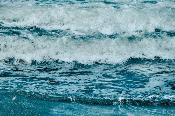 Dynamic waves of the ocean creating frothy splashes on the shoreline, showcasing nature's power and beauty. Nature 4K