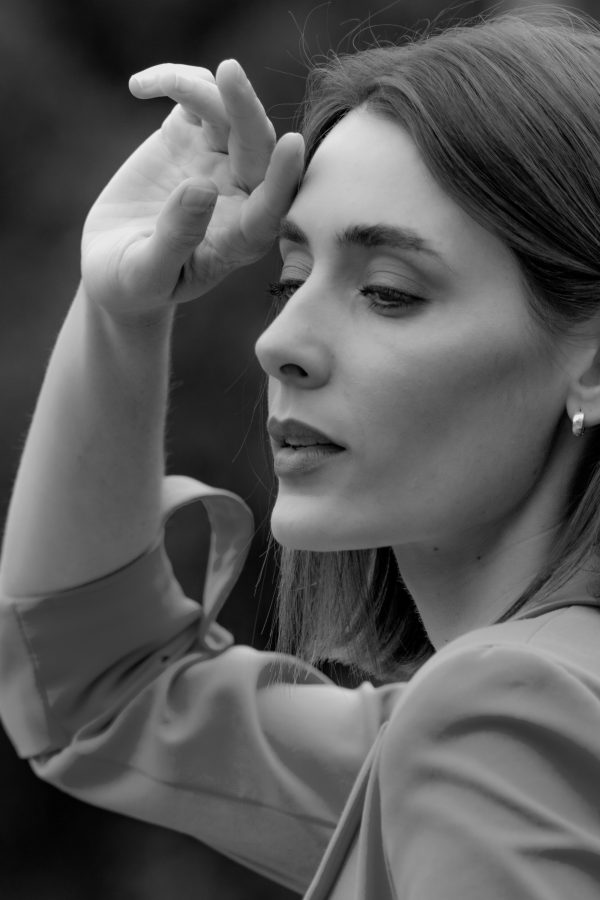 Elegant black and white portrait of a woman with hand in hair, captured in Mexico City. Mobile 4K