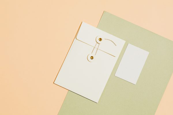 Elegant flat lay of envelopes and paper on yellow background, perfect for office or creative use. Minimaliste 4K
