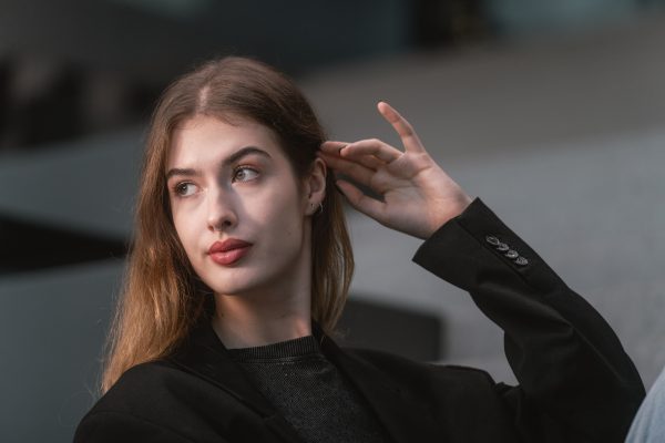 Elegant portrait of a young adult woman in Vienna, showcasing modern fashion and street style. Charme 4K