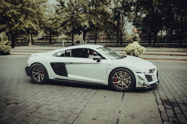 Elegant white Audi R8 V10 parked outdoors, showcasing sleek design in a summer setting. Voitures 4K
