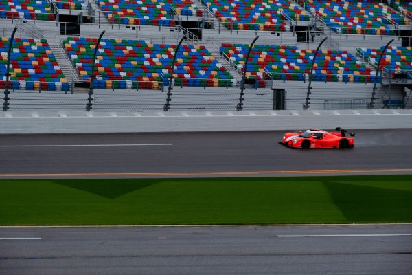 Exciting race car on the track against colorful stadium seating backdrop, showcasing speed and adrenaline. Voitures 4K