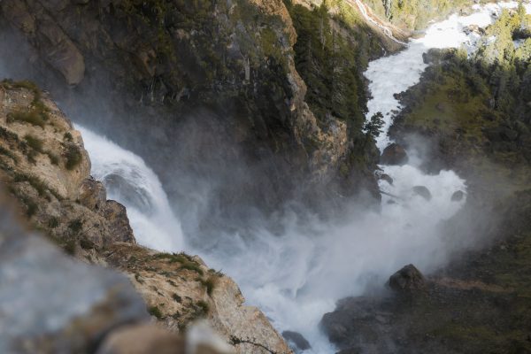 Experience the breathtaking waterfall amidst rocky cliffs and lush greenery in Nepal's Karnali Province. Nature 4K