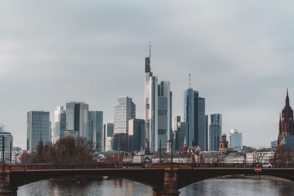 Explore the iconic skyline of Frankfurt featuring modern skyscrapers and historic landmarks over the Main River. Architecture 4K