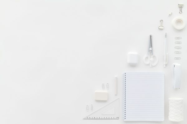 Flat lay of white stationary items on a minimalist office desk with ample copy space. Minimaliste 4K