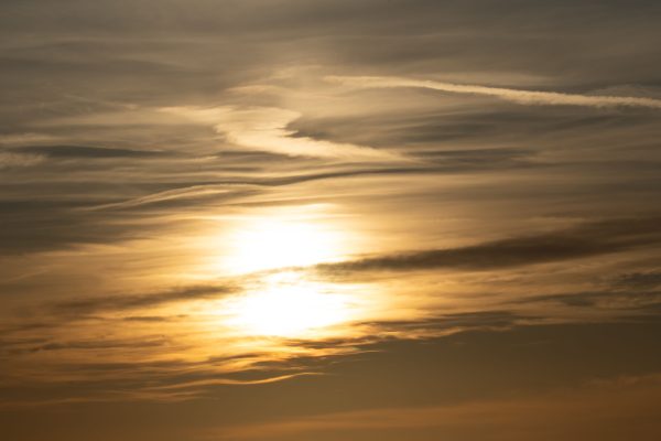 Golden sunset with dramatic cloud formations in a serene sky. Nature 4K