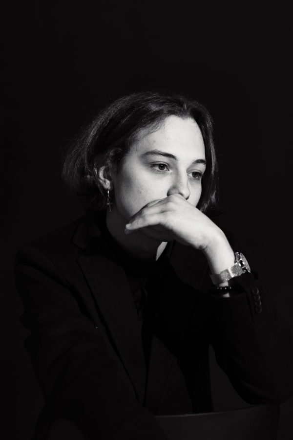 Introspective black and white portrait of a woman with hand over mouth wearing a wristwatch. Mobile 4K
